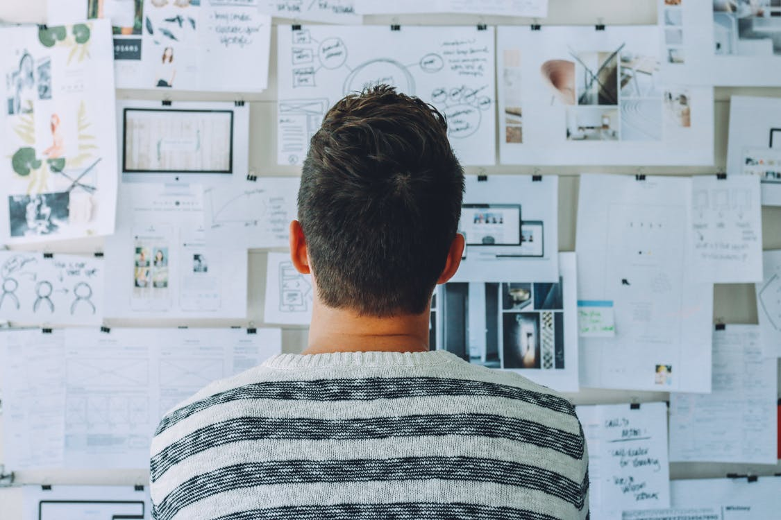 Man looking at a board.